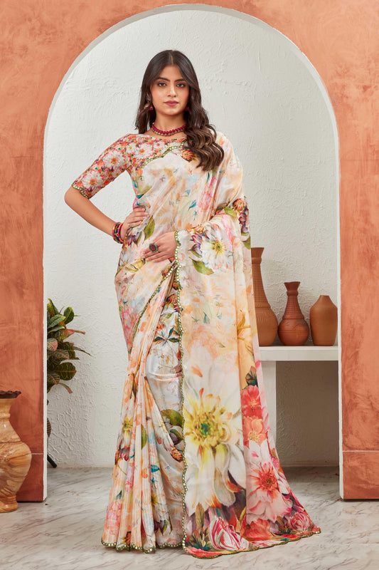 Woman wearing a floral saree standing in front of an archway with decorative vases Glanzavi