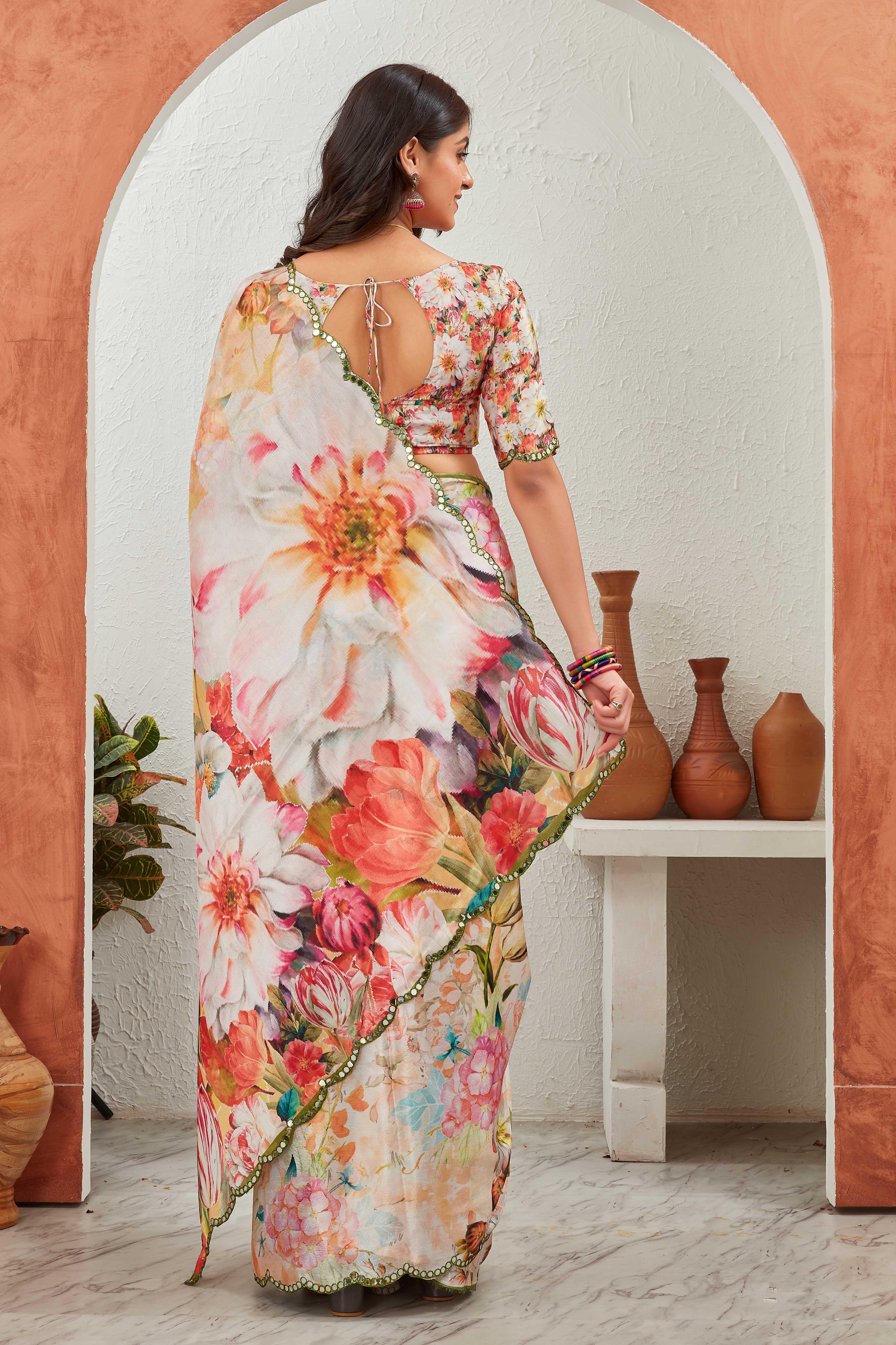 Woman wearing a floral saree in an indoor setting with decorative vases Glanzavi