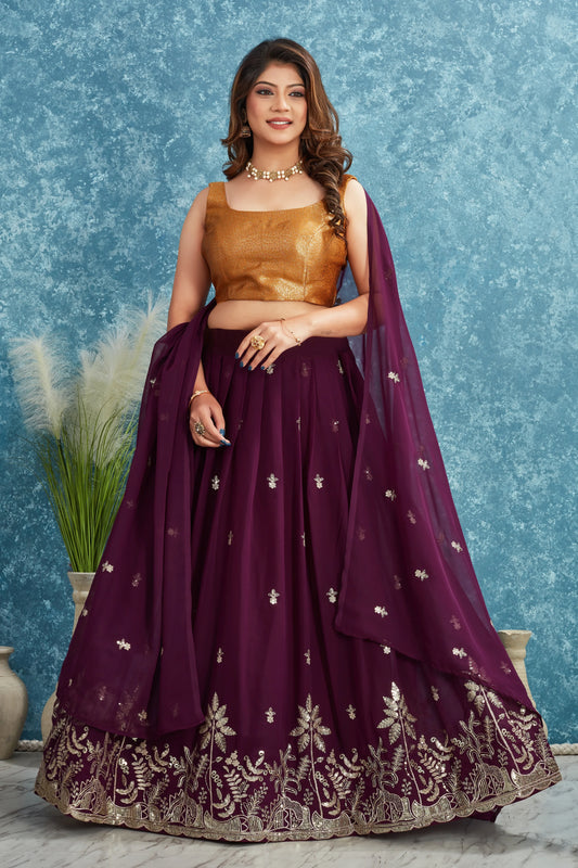 Woman wearing a traditional purple and gold outfit with a blue textured background Glanzavi