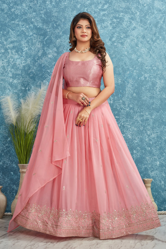 Woman in a pink traditional outfit with a blue textured background Glanzavi