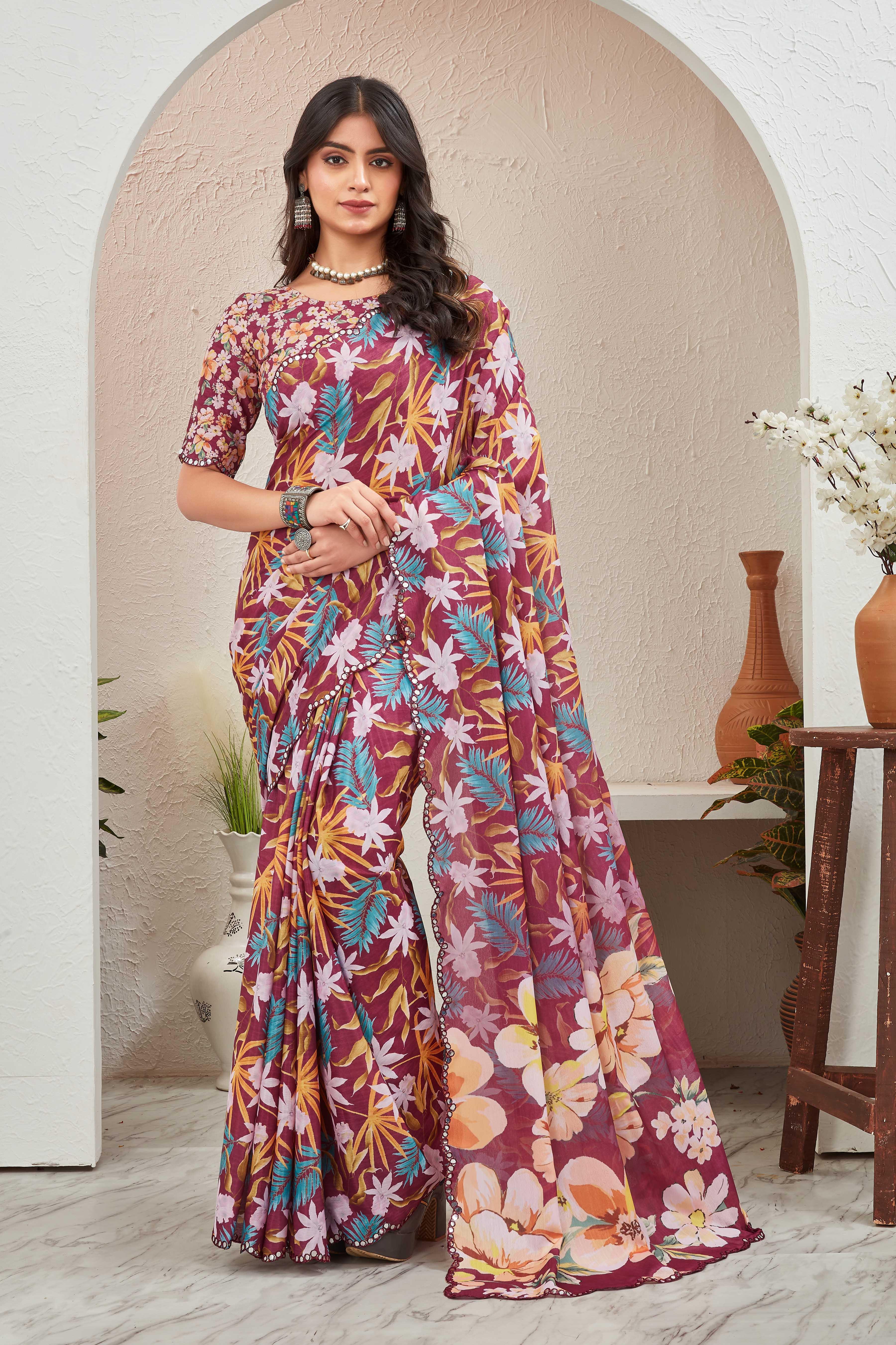 Woman wearing a colorful floral saree indoors with a neutral background Glanzavi