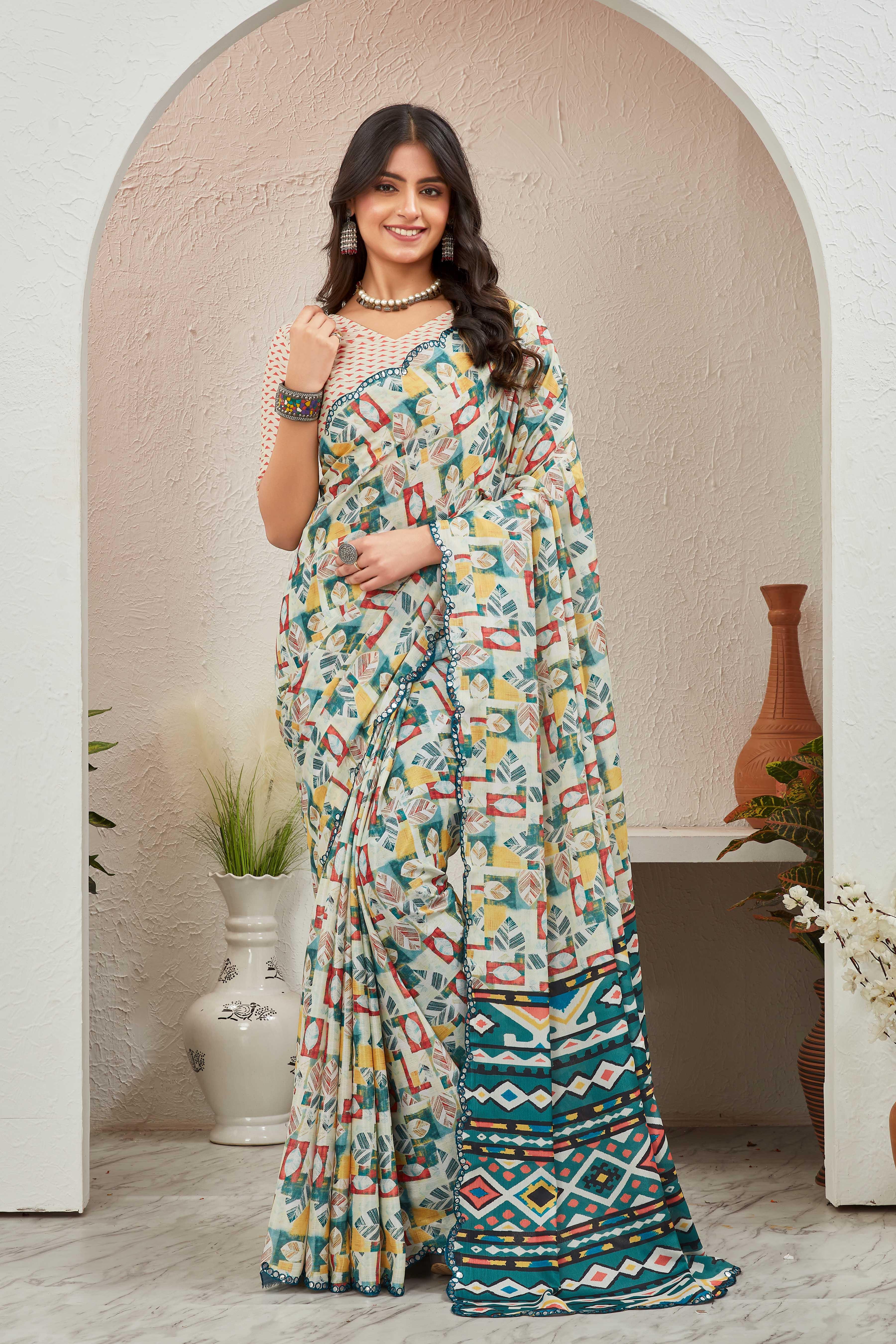 Woman wearing a patterned saree standing in a decorative indoor setting Glanzavi