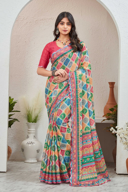 Woman wearing a colorful saree with a pink blouse in an indoor setting.