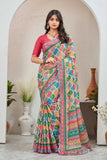 Woman wearing a colorful saree with a pink blouse in an indoor setting.