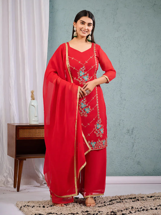 A woman modeling a red georgette embroidered salwar suit with gold embroidery and a dupatta with a golden lace border Glanzavi