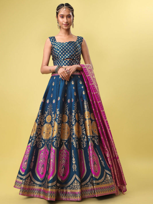 Woman wearing a traditional blue and pink lehenga with a yellow background Glanzavi