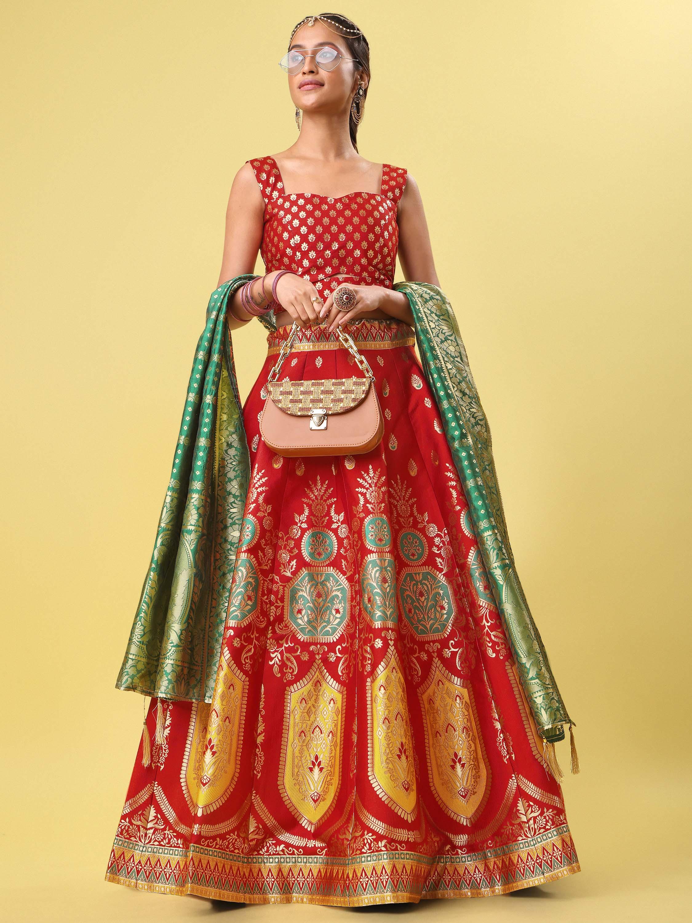 Woman wearing a red and green embroidered traditional outfit on a yellow background Glanzavi