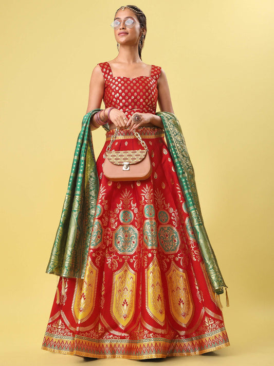 Woman wearing a red and green embroidered traditional outfit on a yellow background Glanzavi