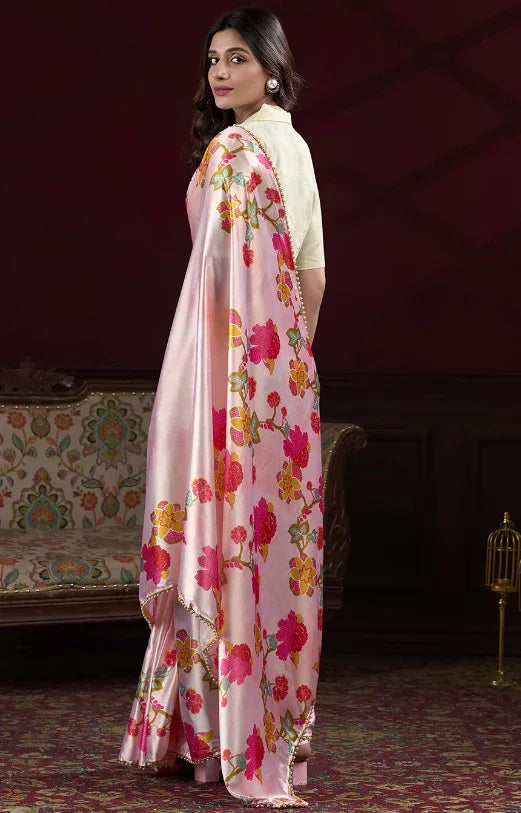 Woman wearing a floral saree in a decorated room Glanzavi