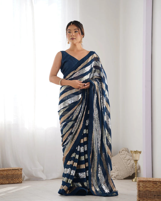 Woman wearing a blue saree with a white background Glanzavi