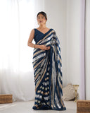 Woman wearing a blue saree with a white background Glanzavi
