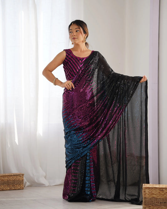 A woman modeling a multicolor ombre sequin saree with stripes of black, magenta, and blue hues, paired with a matching blouse Glanzavi