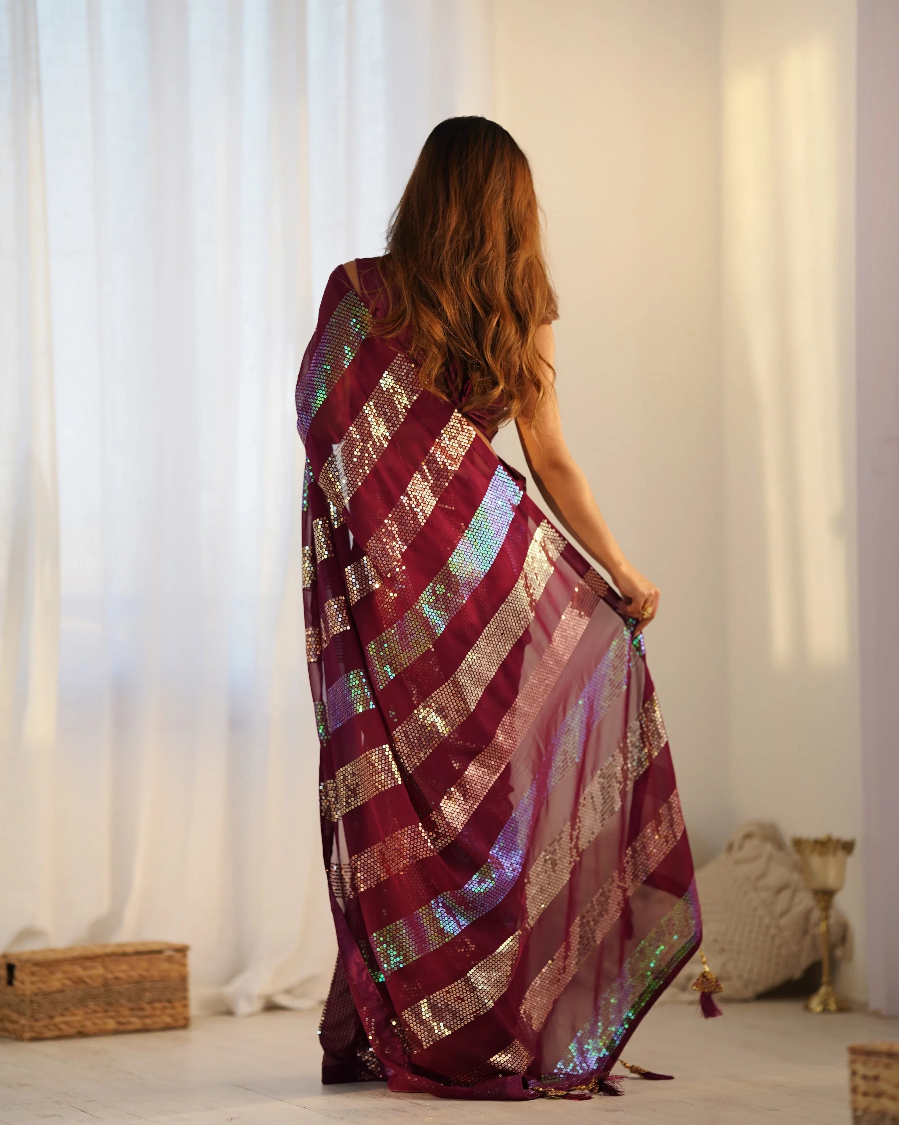 Woman wearing a colorful saree in a minimal indoor setting Glanzavi