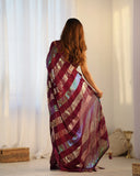 Woman wearing a colorful saree in a minimal indoor setting Glanzavi