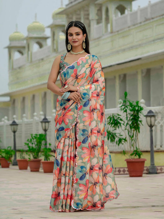 Woman in a floral saree standing in front of a building with architectural elements Glanzavi.