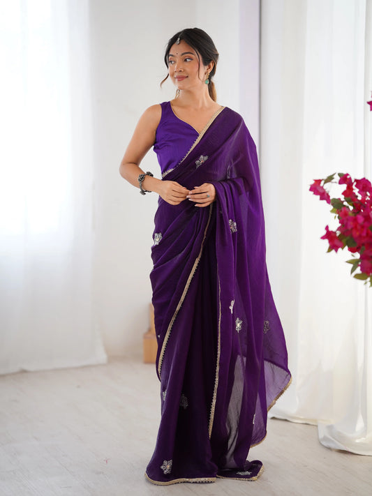 Woman wearing a purple saree with a white background Glanzavi