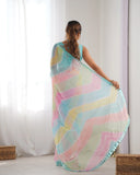 Woman wearing a colorful, patterned scarf in a room with white curtains Glanzavi