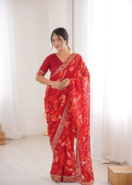 Woman wearing a red saree with white patterns in a minimal indoor setting Glanzavi