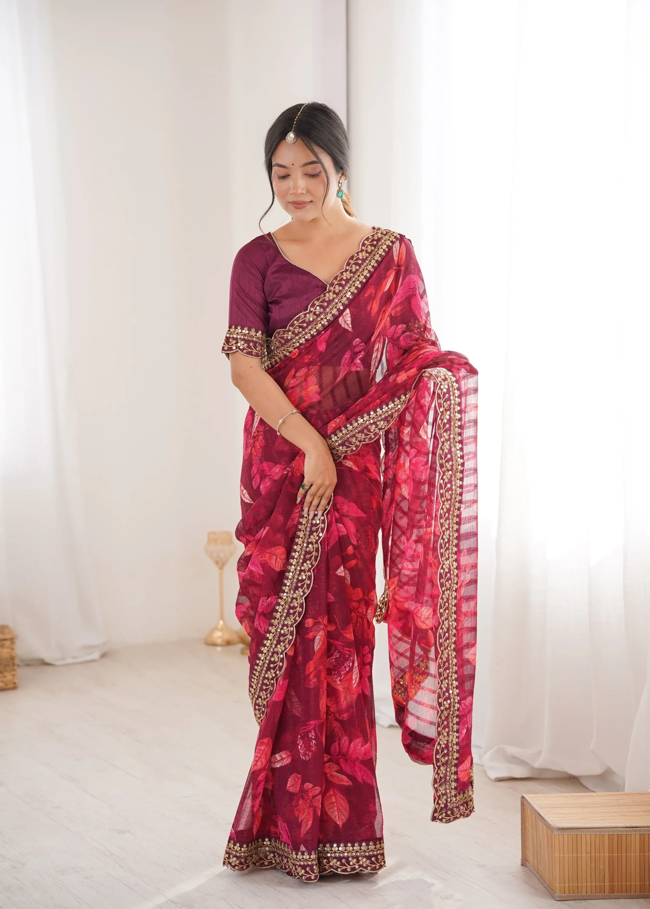Woman wearing a red and purple saree with gold border against a white background Glanzavi