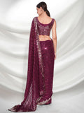 Woman wearing a maroon saree with a white background Glanzavi
