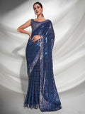 Woman wearing a blue saree with silver sequins on a white background Glanzavi