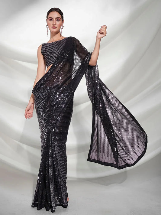 Woman wearing a black saree with a white background Glanzavi