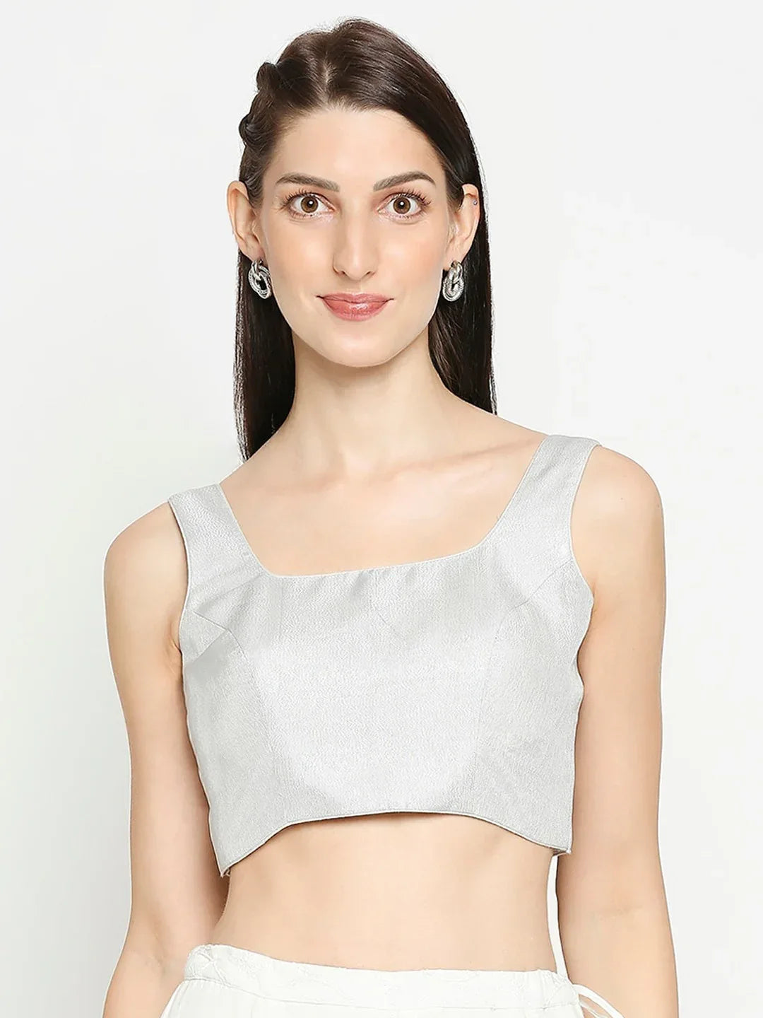 Woman wearing a light gray sleeveless top against a white background Glanzavi