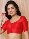 Woman wearing a red blouse against a beige background Glanzavi