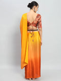 Woman wearing a yellow and orange saree with a red blouse on a light gray background Glanzavi