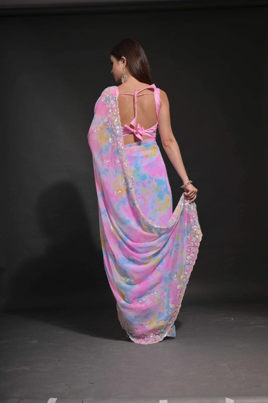 Woman wearing a colorful saree with a pink blouse against a black background Glanzavi