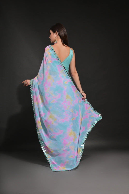 Woman wearing a colorful floral saree with a dark background Glanzavi