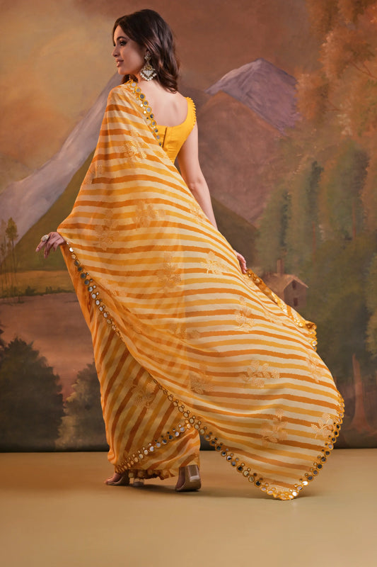 Woman in a yellow and white striped saree with a scenic background Glanzavi