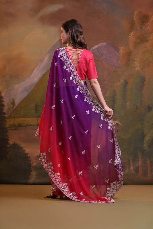 Woman wearing a purple and pink saree with a scenic background Glanzavi