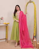 Woman in green outfit with pink dupatta standing next to a decorative mirror Glanzavi