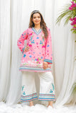 Woman wearing a pink embroidered shirt and white pants against a white curtain background Glanzavi