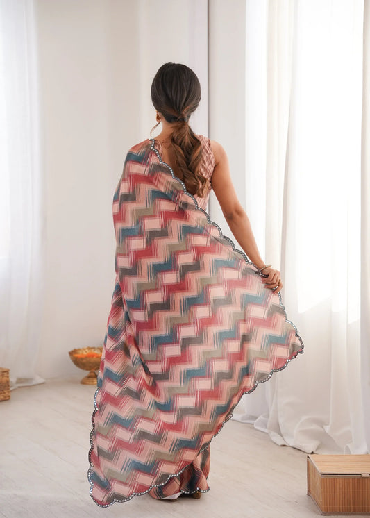 Woman wearing a colorful saree in a minimal indoor setting Glanzavi