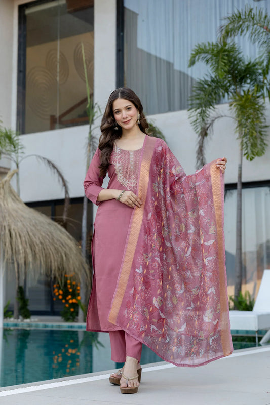 Woman in a pink traditional outfit with a matching dupatta by a poolside Glanzavi
