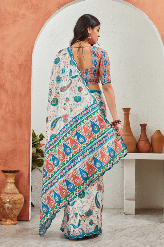 Woman in a colorful patterned saree standing in front of an archway with decorative vases Glanzavi.