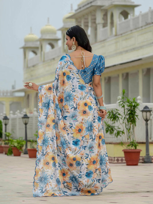 Woman in a floral saree standing in front of a building with domes Glanzavi.