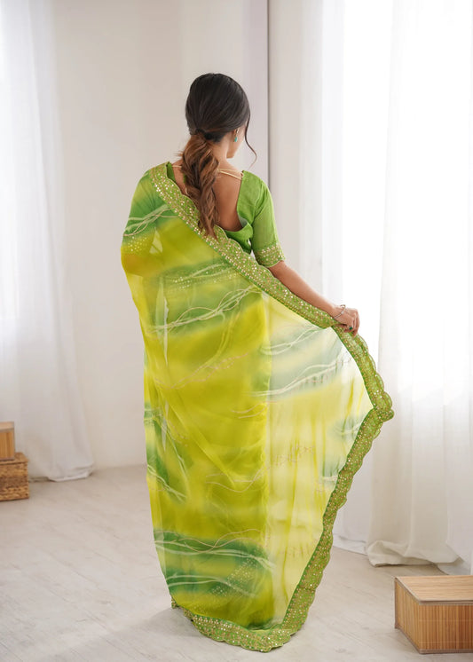 Woman wearing a green and yellow saree in a room with white curtains Glanzavi.