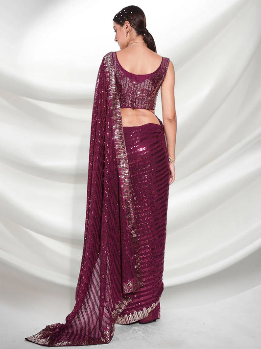 Woman wearing a maroon saree with a white background Glanzavi