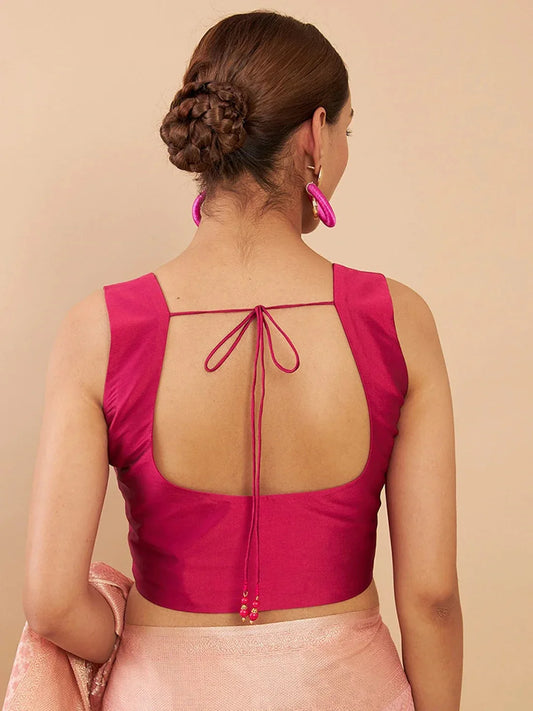 Woman wearing a pink blouse with an open back on a beige background Glanzavi